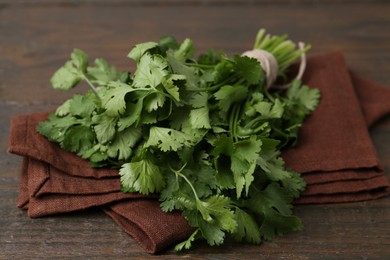 Photo of Fresh aromatic cilantro on wooden table, closeup