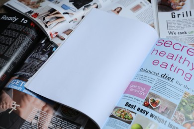 Photo of Different trendy magazines as background, closeup. Mockup for design
