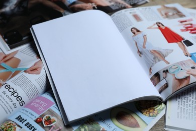 Photo of Different trendy magazines as background, closeup. Mockup for design