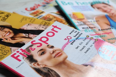 Photo of Many different trendy magazines as background, closeup