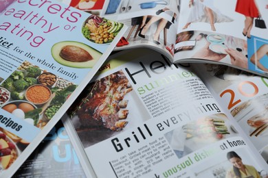 Photo of Many different trendy magazines as background, closeup