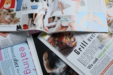 Photo of Many different trendy magazines as background, closeup