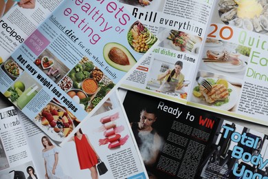 Photo of Many different trendy magazines as background, closeup