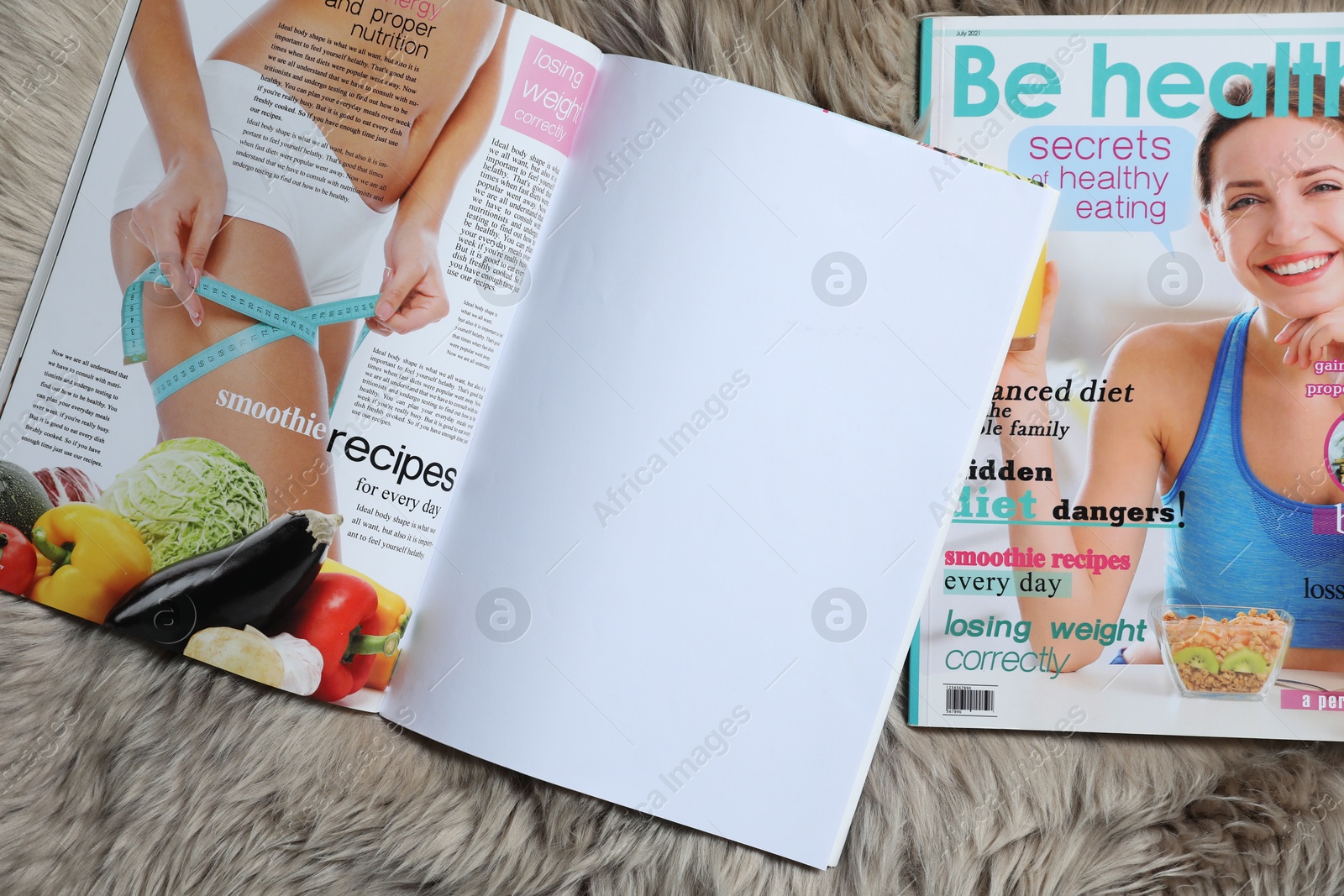 Trendy magazines on faux fur, top view. Mockup for design Photo of Trendy magazines on faux fur, top view. Mockup for design