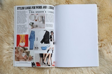 Photo of Open magazine on faux fur, top view. Mockup for design