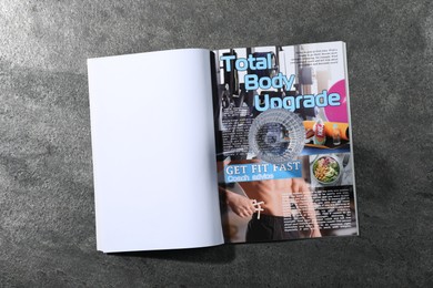 Photo of Open magazine on grey background, top view. Mockup for design