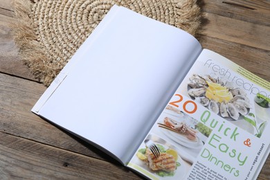 Photo of Open magazine on wooden background, closeup. Mockup for design