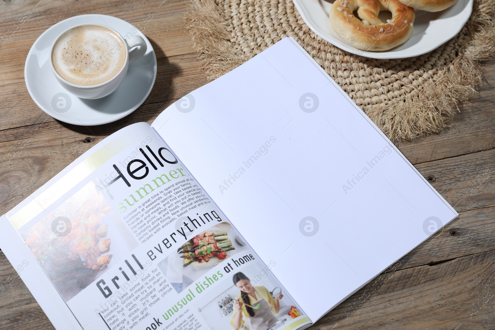 Open magazine, pretzels and coffee on wooden background, closeup. Mockup for design Photo of Open magazine, pretzels and coffee on wooden background, closeup. Mockup for design