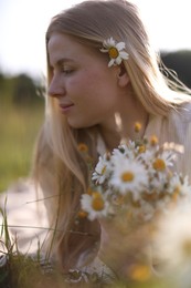 Photo of Beautiful woman with wildflowers in meadow on sunny day