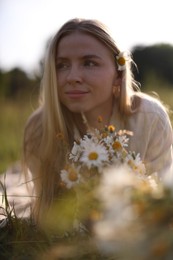 Photo of Beautiful woman with wildflowers in meadow on sunny day