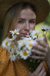 Photo of Beautiful woman with bouquet of wildflowers in forest
