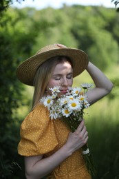 Photo of Beautiful woman with bouquet of wildflowers in forest