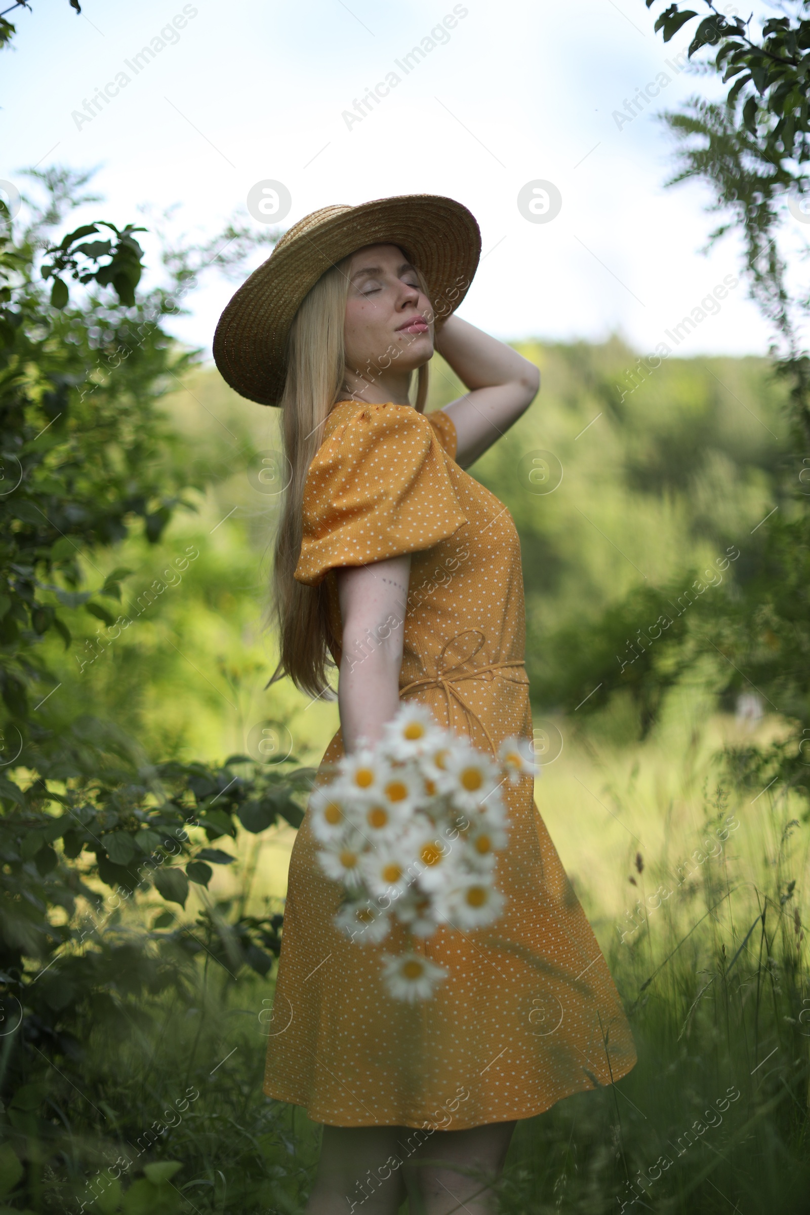 Photo of Beautiful woman with bouquet of wildflowers in forest