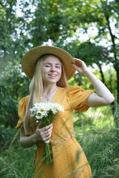 Photo of Beautiful woman with bouquet of wildflowers in forest