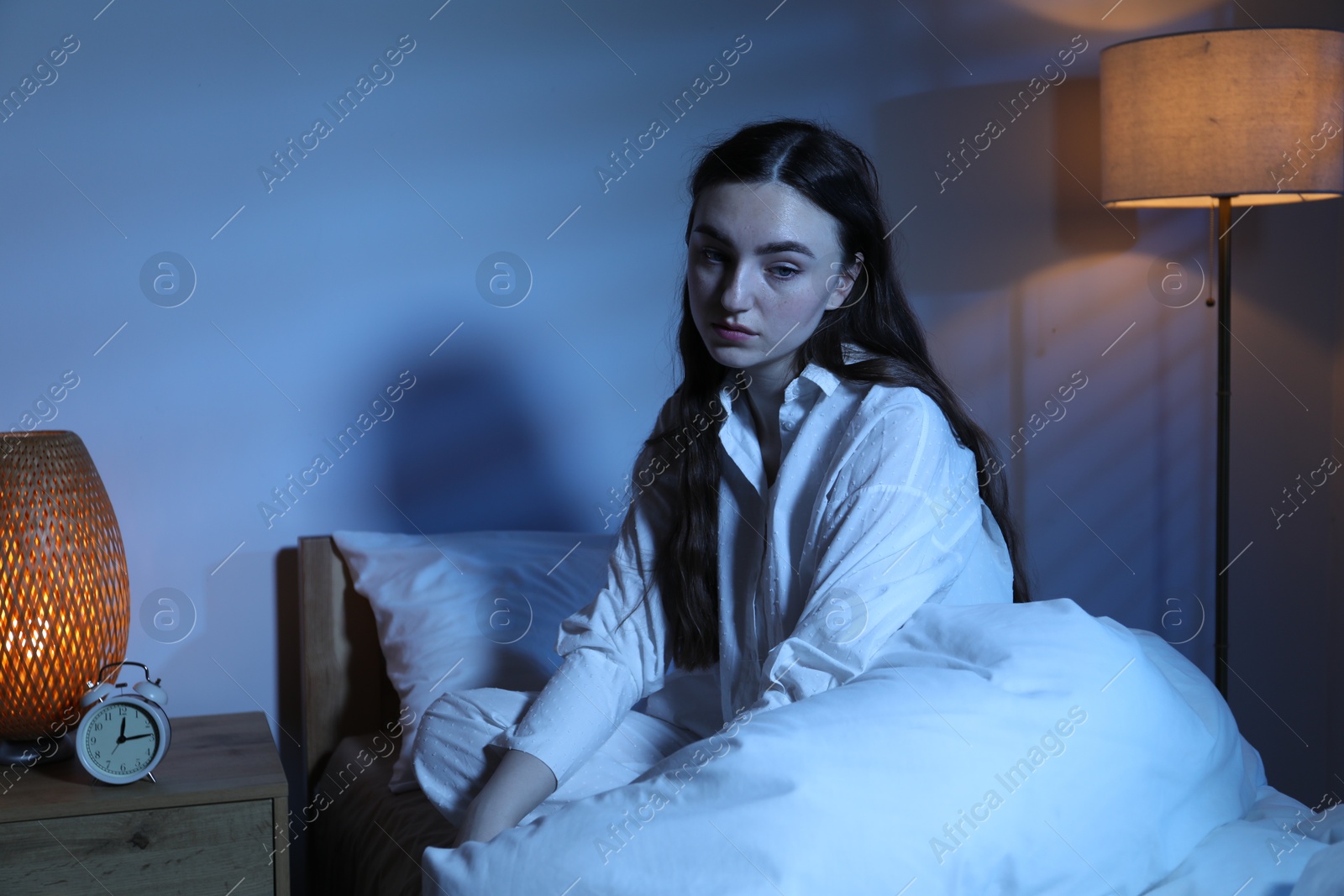 Frustrated woman suffering from insomnia on bed at home Photo of Frustrated woman suffering from insomnia on bed at home