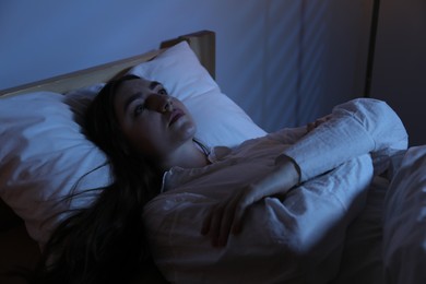 Photo of Frustrated woman suffering from insomnia in bed at home