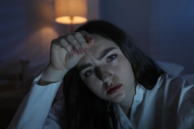 Photo of Frustrated woman suffering from insomnia at home