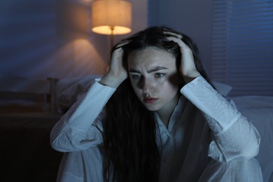 Photo of Frustrated woman suffering from insomnia at home