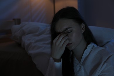 Photo of Frustrated woman suffering from insomnia at home, space for text