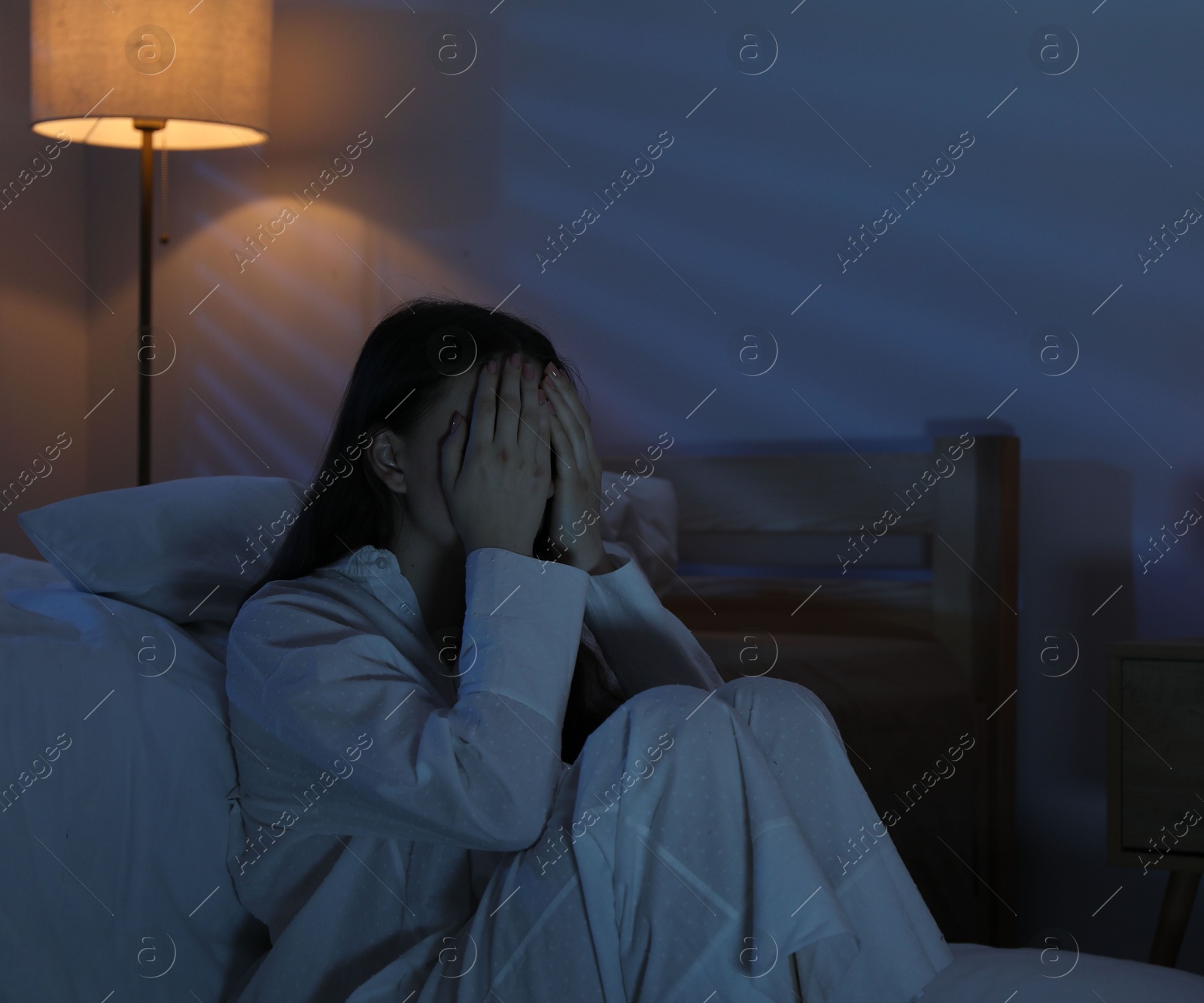 Frustrated woman suffering from insomnia on floor at home Photo of Frustrated woman suffering from insomnia on floor at home
