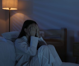 Photo of Frustrated woman suffering from insomnia on floor at home