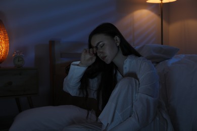 Photo of Frustrated woman suffering from insomnia on floor at home