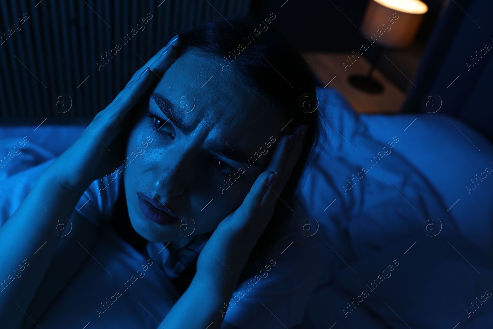 Frustrated woman with pillow suffering from insomnia on bed at home Photo of Frustrated woman with pillow suffering from insomnia on bed at home