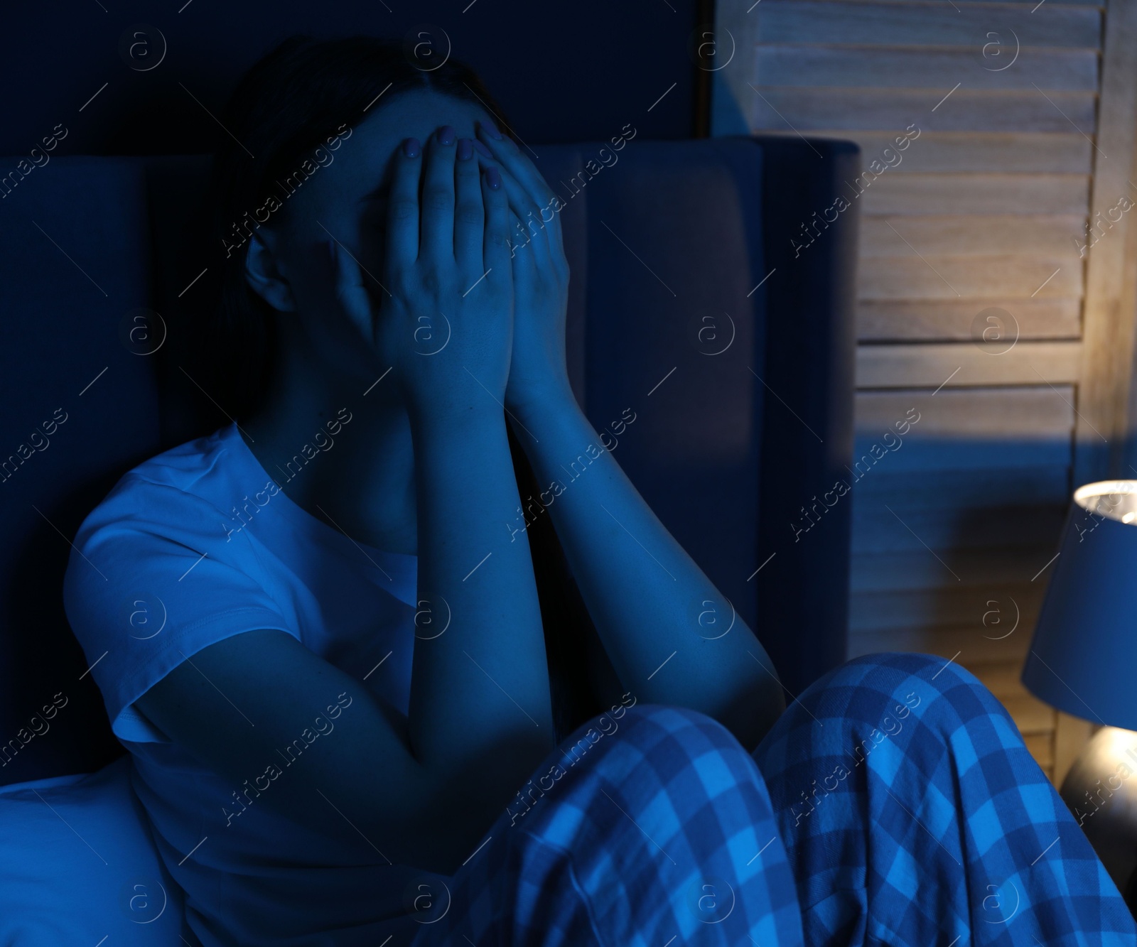 Frustrated woman suffering from insomnia on bed at home Photo of Frustrated woman suffering from insomnia on bed at home