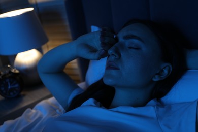 Photo of Frustrated woman suffering from insomnia in bed at home