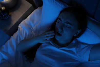 Photo of Frustrated woman suffering from insomnia in bed at home, above view