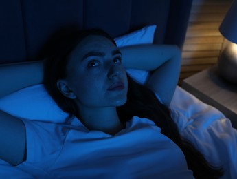 Photo of Frustrated woman suffering from insomnia in bed at home