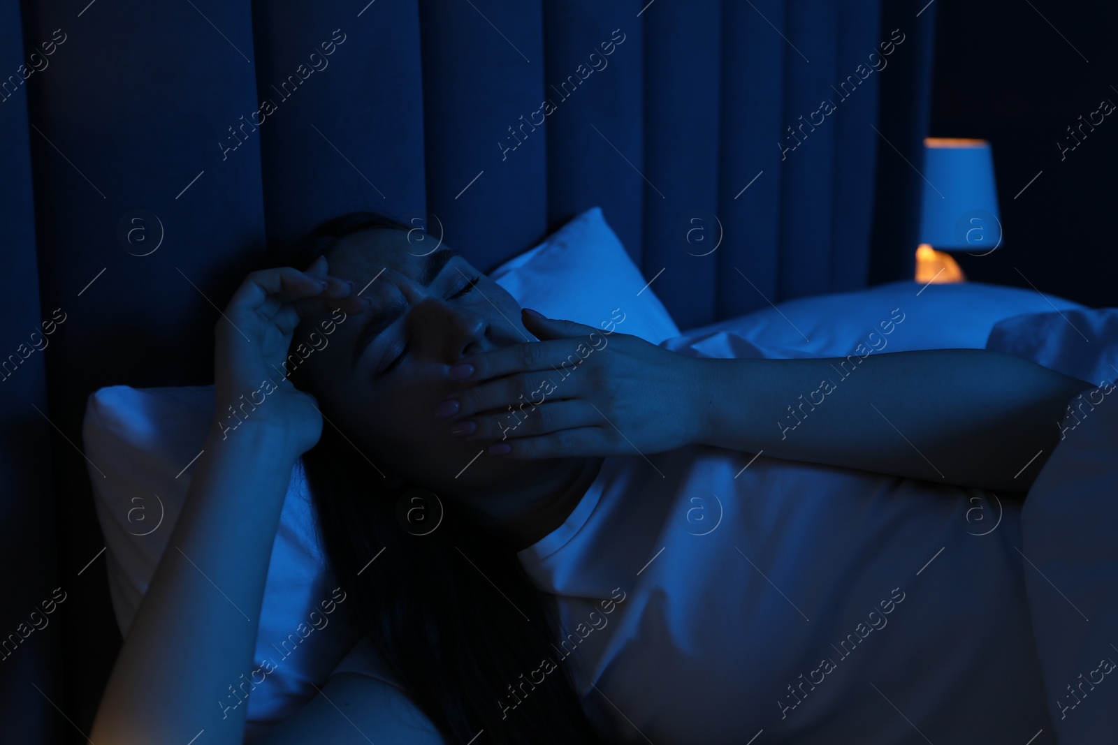 Photo of Frustrated woman suffering from insomnia in bed at home