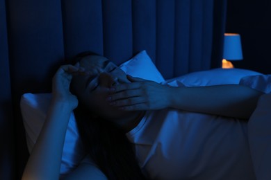 Photo of Frustrated woman suffering from insomnia in bed at home