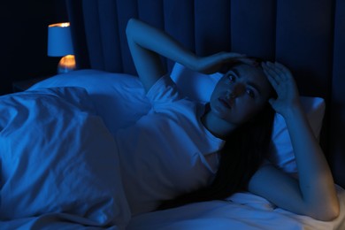 Photo of Frustrated woman suffering from insomnia in bed at home