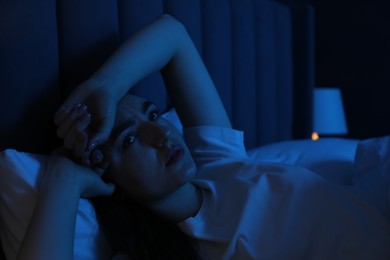 Photo of Frustrated woman suffering from insomnia in bed at home