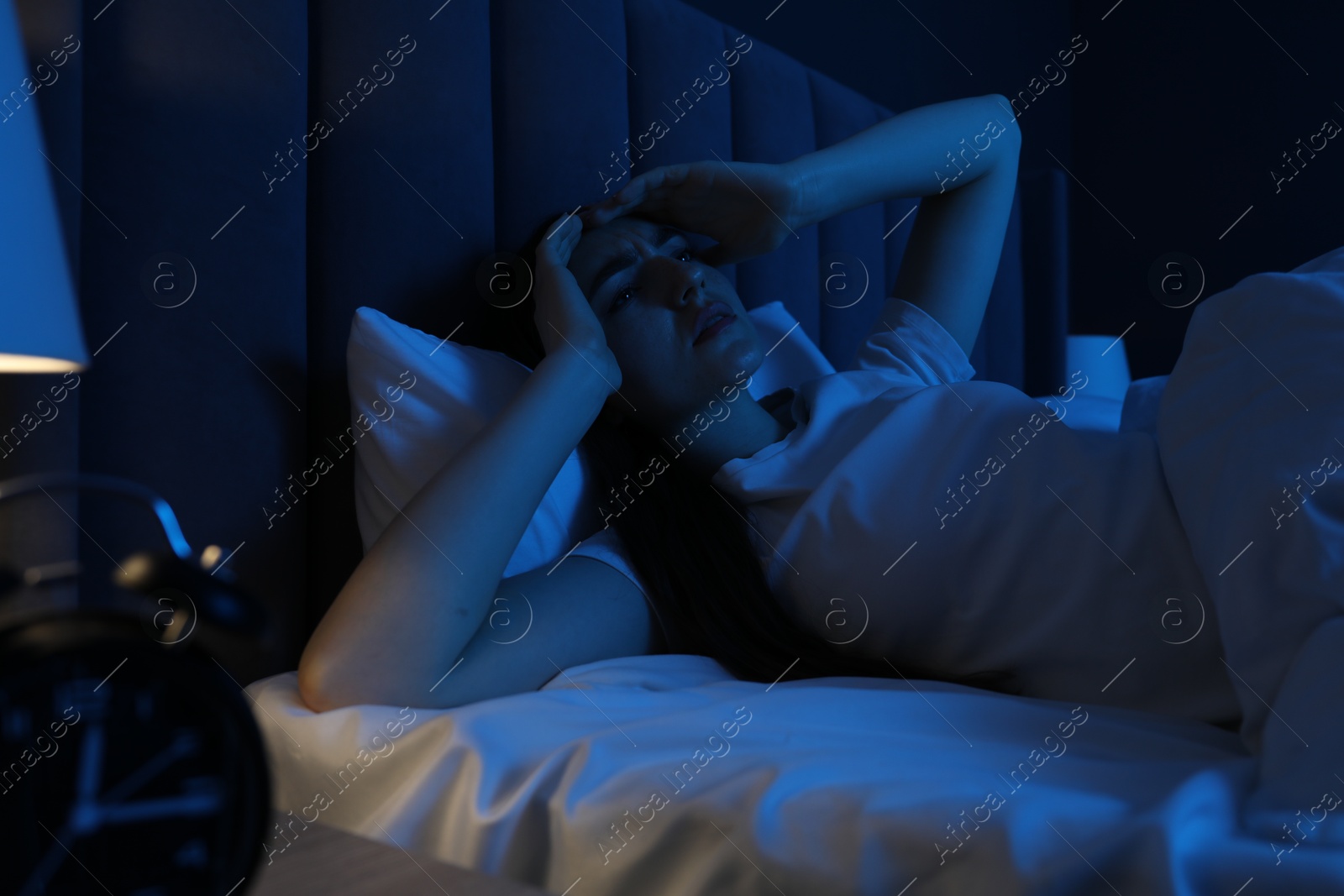 Frustrated woman suffering from insomnia in bed at home Photo of Frustrated woman suffering from insomnia in bed at home