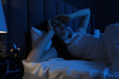 Photo of Frustrated woman suffering from insomnia in bed at home