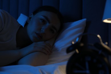 Photo of Frustrated woman suffering from insomnia in bed at home