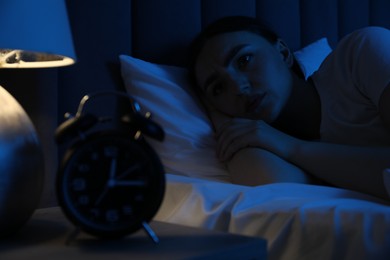 Photo of Frustrated woman suffering from insomnia in bed at home
