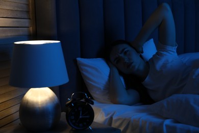 Photo of Frustrated woman suffering from insomnia in bed at home