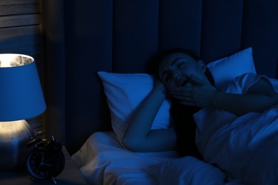 Photo of Frustrated woman suffering from insomnia in bed at home