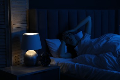 Photo of Frustrated woman suffering from insomnia in bed at home