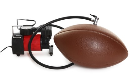 Photo of American football ball and air compressor isolated on white