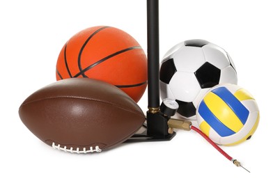 Photo of Different sport balls and manual air pump isolated on white