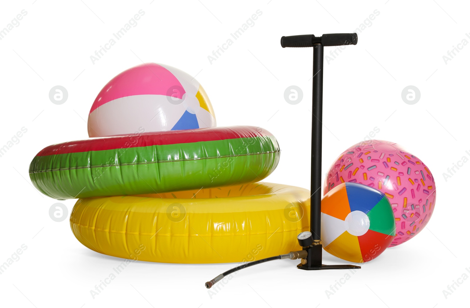 Inflatable rings, balls and manual air pump isolated on white Photo of Inflatable rings, balls and manual air pump isolated on white