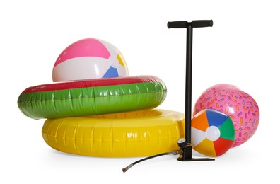 Photo of Inflatable rings, balls and manual air pump isolated on white
