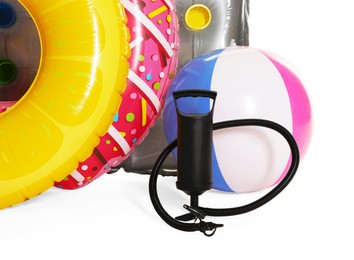 Photo of Inflatable rings, mattress, ball and manual air pump isolated on white
