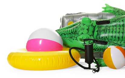 Photo of Inflatable ring, mattress, balls and manual air pump isolated on white