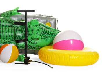 Photo of Inflatable ring, mattress, balls and manual air pump isolated on white