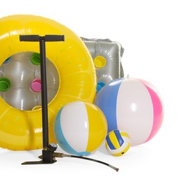 Photo of Inflatable ring, mattress, balls and manual air pump isolated on white